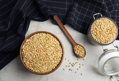 Uncooked green buckwheat grains on table, flat lay