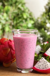 Delicious pitahaya smoothie and fresh fruits on wooden table