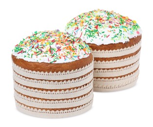 Photo of Traditional Easter cakes with sprinkles on white background