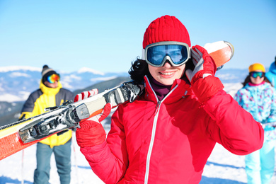 Photo of Young woman with ski at resort. Winter vacation