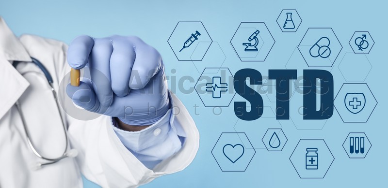 STD prevention. Closeup view of doctor with suppository , abbreviation and different icons on light blue background, banner design