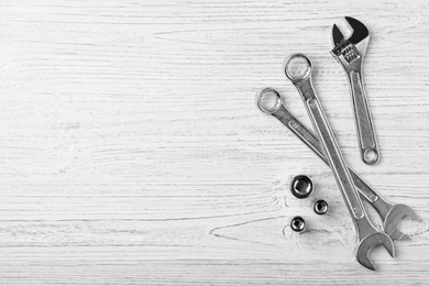 Auto mechanic's tools on white wooden background, flat lay. Space for text