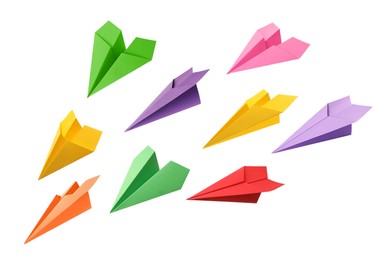 Set with handmade different color paper planes on white background