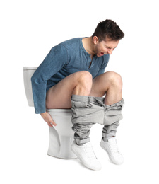 Man suffering from diarrhea on toilet bowl, white background