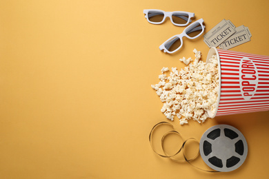 Flat lay composition with delicious popcorn on yellow background. Space for text