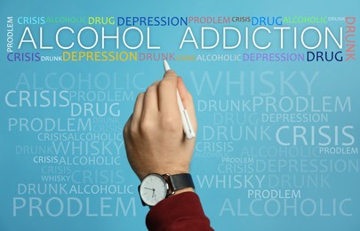 Alcohol addiction? - We can help you. Closeup view of man with pen against light blue background