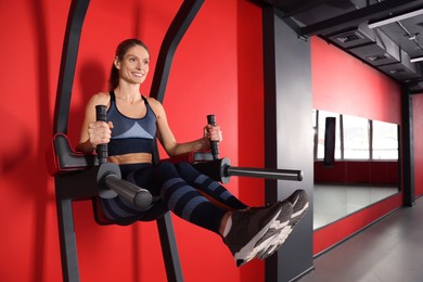 Photo of Woman training on power tower in gym