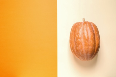 Pumpkin and space for text on color background, top view. Autumn holidays