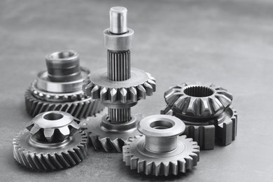 Photo of Many different stainless steel gears on light grey background