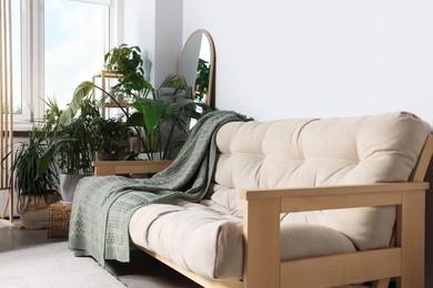 Photo of Stylish living room interior with comfortable sofa and beautiful houseplants