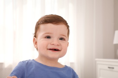 Happy baby boy in room at home