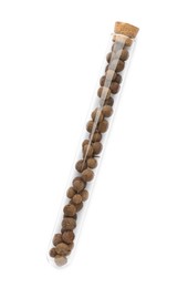 Glass tube with allspice peppercorns on white background, top view