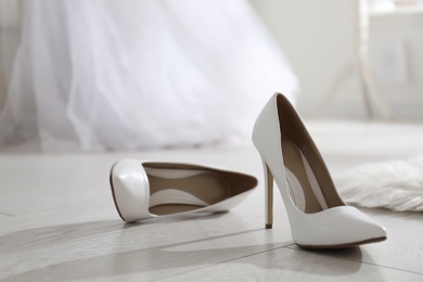 White wedding shoes on floor in room
