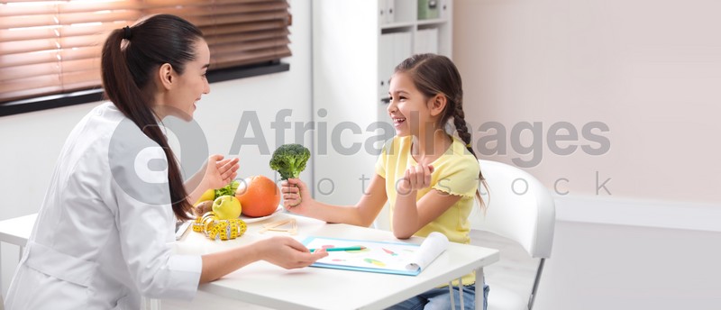 Little girl visiting professional nutritionist in office. Banner design