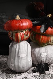 Photo of Colorful pumpkins on rug near fireplace. Halloween decorations