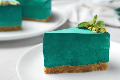Delicious homemade spirulina cheesecake served on light table