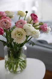 Bouquet of beautiful ranunculuses on table in bedroom