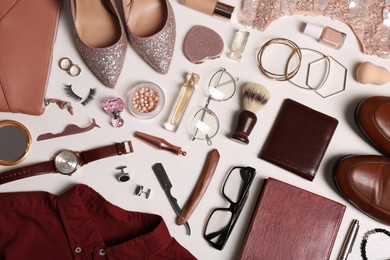 Flat lay composition with fashionable woman's and man's accessories on light background