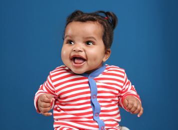Cute African American baby on blue background