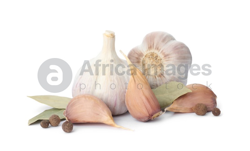Fresh garlic bulbs and cloves with seasonings isolated on white. Organic food