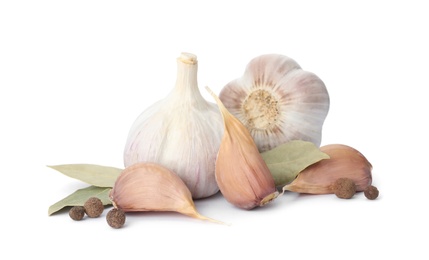 Fresh garlic bulbs and cloves with seasonings isolated on white. Organic food
