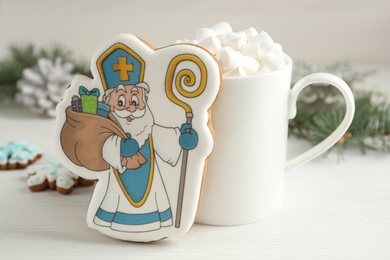 Delicious gingerbread cookies and hot drink on white wooden table. St. Nicholas Day celebration