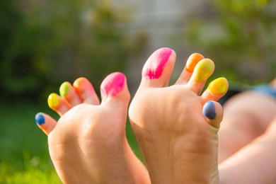 Photo of Teenage girl with painted toes outdoors, closeup