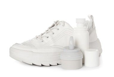 Composition with stylish footwear and shoe care accessories on white background