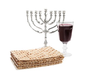 Traditional matzos, red wine and menorah on white background