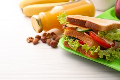 Serving tray of healthy food and space for text on white wooden table, closeup. School lunch