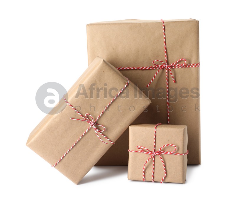 Gift boxes wrapped in kraft paper with bows on white background