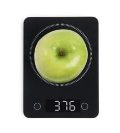 Ripe green apple and electronic scales on white background, top view