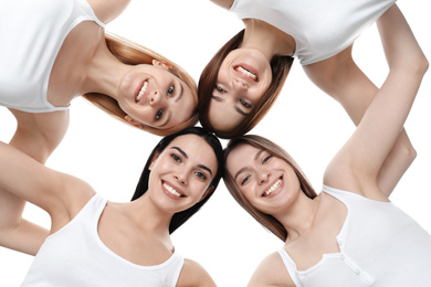 Beautiful young ladies hugging on white background, bottom view. Women's Day