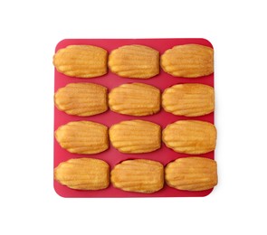 Photo of Tasty madeleine cookies in baking mold isolated on white, top view