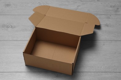 One empty open cardboard box on floor
