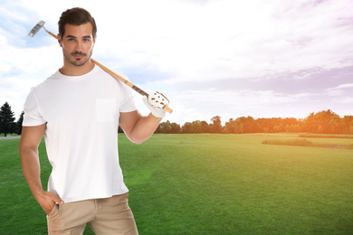 Young man with golf club on green course. Space for design
