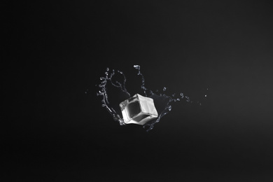 Crystal clear ice cube on black background