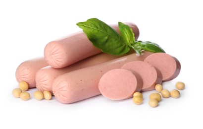 Fresh raw vegetarian sausages, basil and soybeans on white background