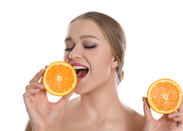 Young woman with cut orange on white background. Vitamin rich food