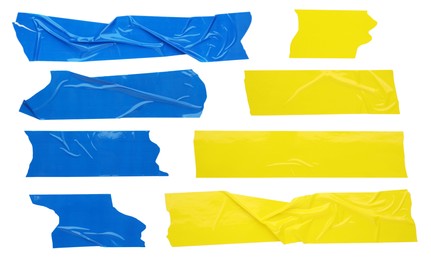 Set with pieces of blue and yellow adhesive tapes on white background, top view