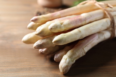 Bunch of fresh white asparagus on wooden table, closeup