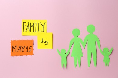 Photo of Paper cutout and cards with text Family Day on pink background, flat lay
