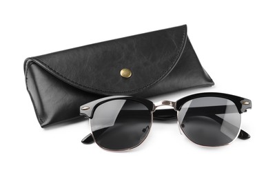 Modern sunglasses and black case on white background