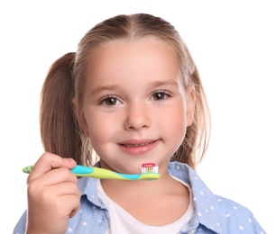 Little girl holding toothbrush with paste on white background