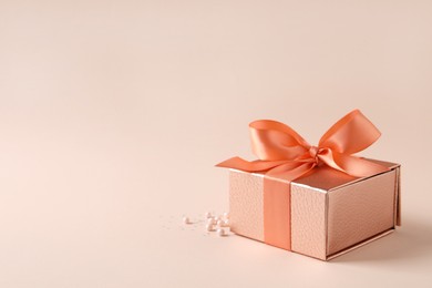 Beautiful gift box and decor on pink background, space for text