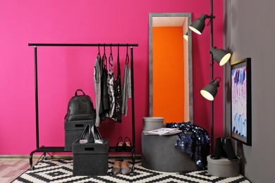 Stylish dressing room interior with clothes rack and mirror
