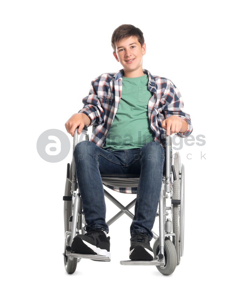 Teenage boy in wheelchair on white background