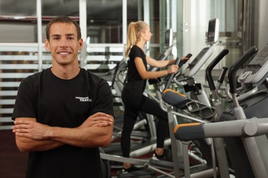Photo of Portrait of personal trainer in modern gym