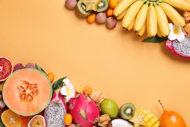 Different exotic fruits on beige background, flat lay. Space for text