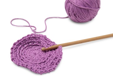 Soft violet woolen yarn, knitting and crochet hook on white background, closeup